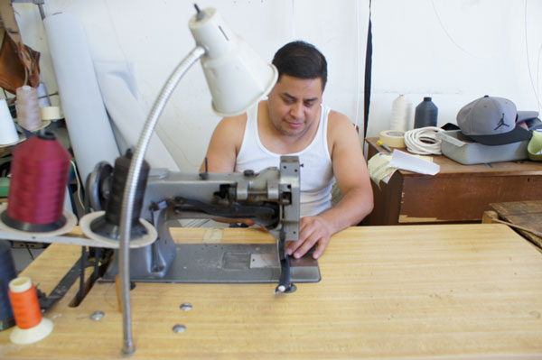 Employee sewing at ML Upholstery Shop upholstery shop in inglewood