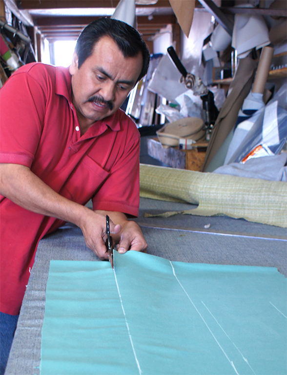Cutting upholstery fabrics at our local upholstery shop. Upholsterer cutting fabrics at ML Upholstery