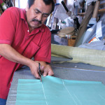 Upholsterer cutting fabrics at ML Upholstery